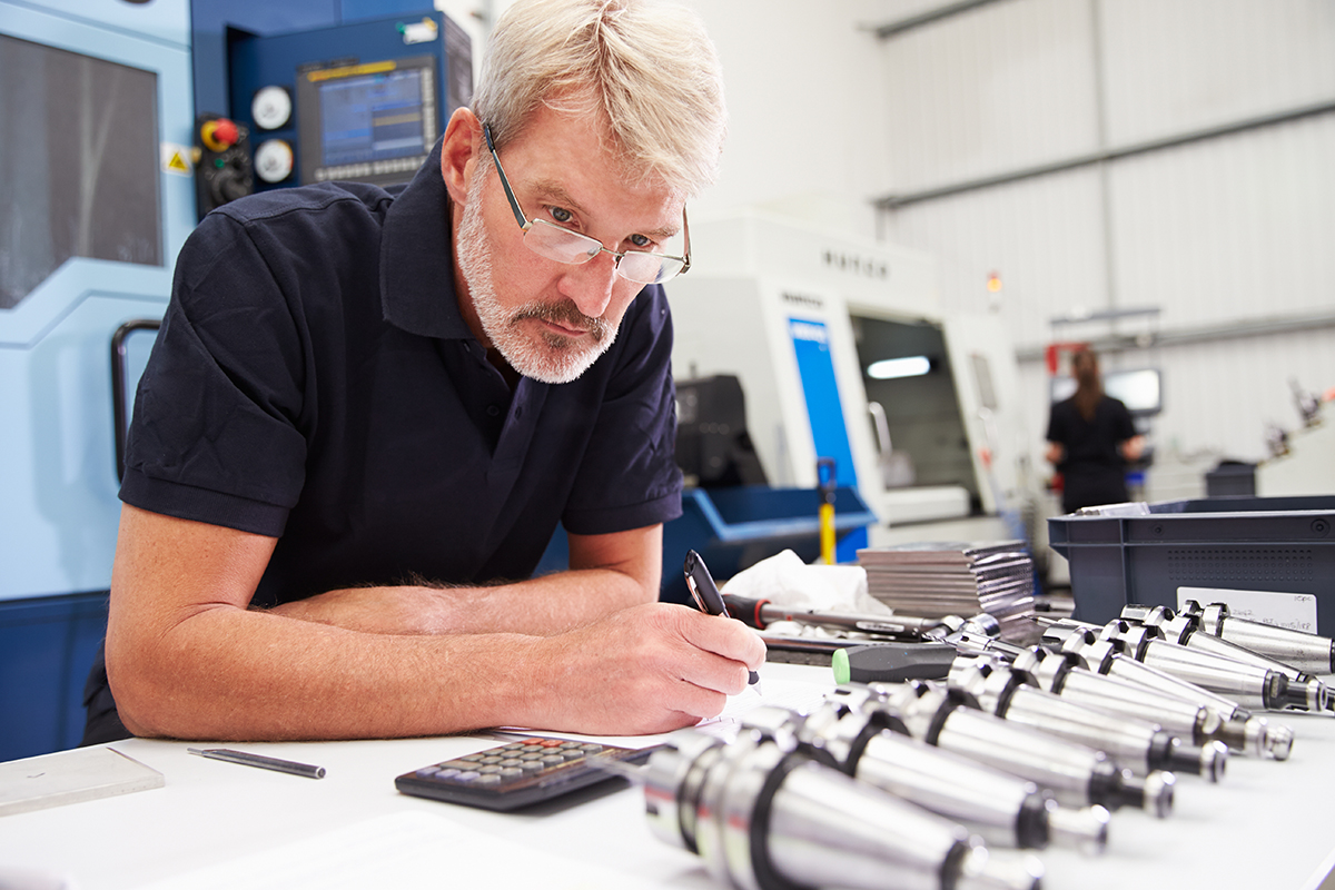 adult caucasian male looking at bits for a cnc machine